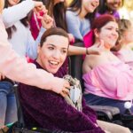 Women with cerebral palsy outdoors celebrating 8th march with their feminist friends, togetherness with sorority for inclusion and female rights