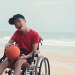 Boy in wheelchair with ball